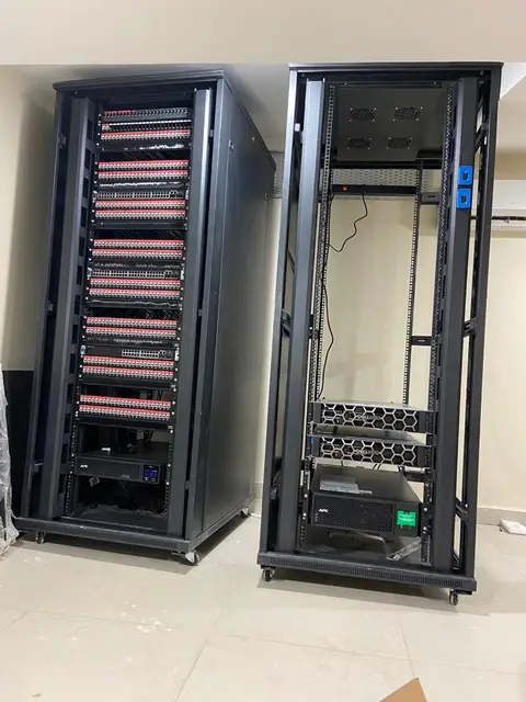 The core network room: patch panels for every data point on the left, servers and UPS on the right.