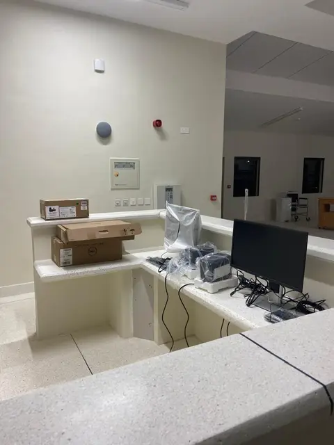 A ceiling PA speaker above a nurses’ station, for announcements and paging across the ward.