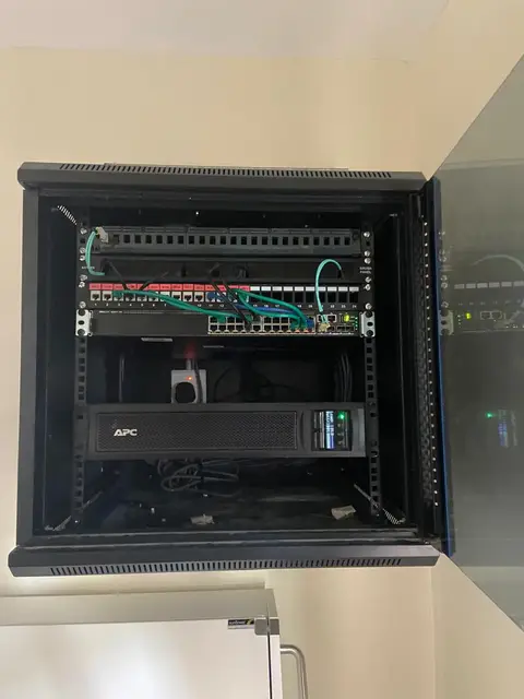 A wall-mounted network cabinet serving a ward, with its own switch and UPS so the floor stays connected through power cuts.